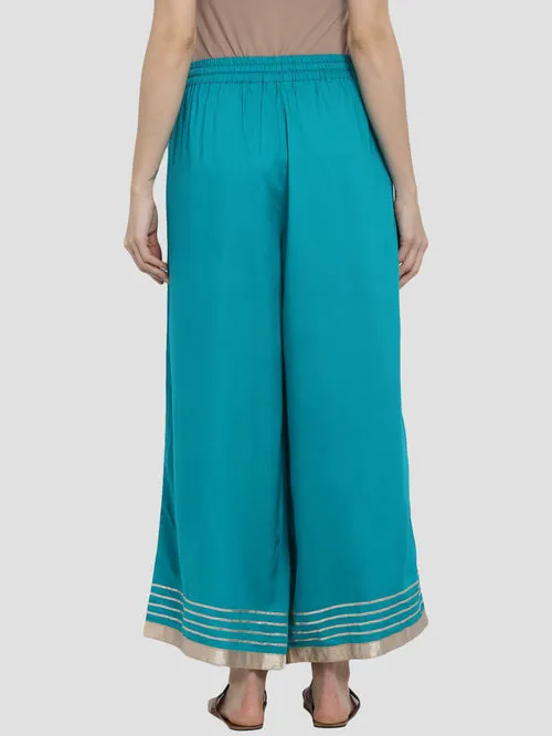 “Elegant Teal Green Palazzo Pants with Golden Border and Tassel Waistband - Luxe Fashion Piece”